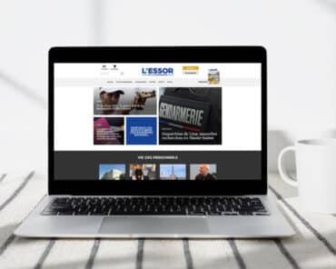 Aperçu de la page d'accueil du nouveau site web d'information en continue de L'Essor sur l'écran d'un ordinateur portable posé sur une table.